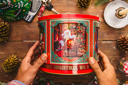 Christmas musical tin held in hands on a festive table